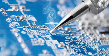 Microcircuit being fixed with soldering iron - very sharp micro photo