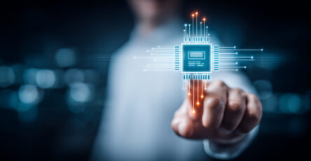 Business hand touching a virtual microchip interface symbolizing AI computing power and innovation.
